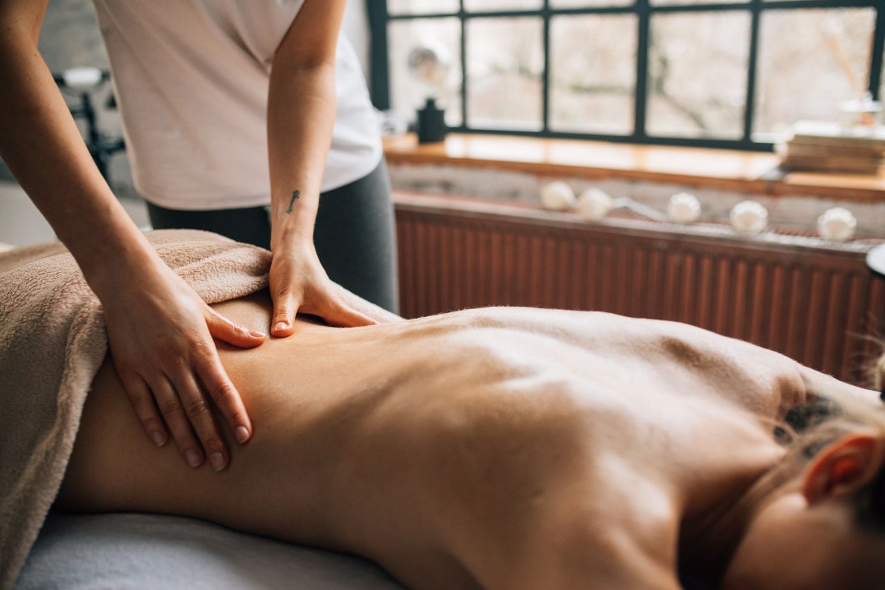A therapist giving a relaxing massage treatment